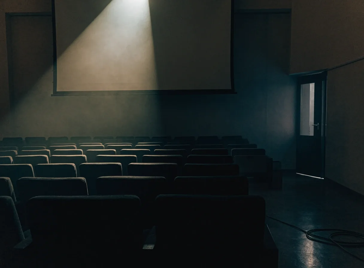 An empty evening classroom with a projector light falling on a blank wall